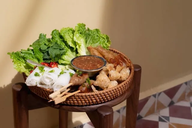 A table set with shared dishes under warm light