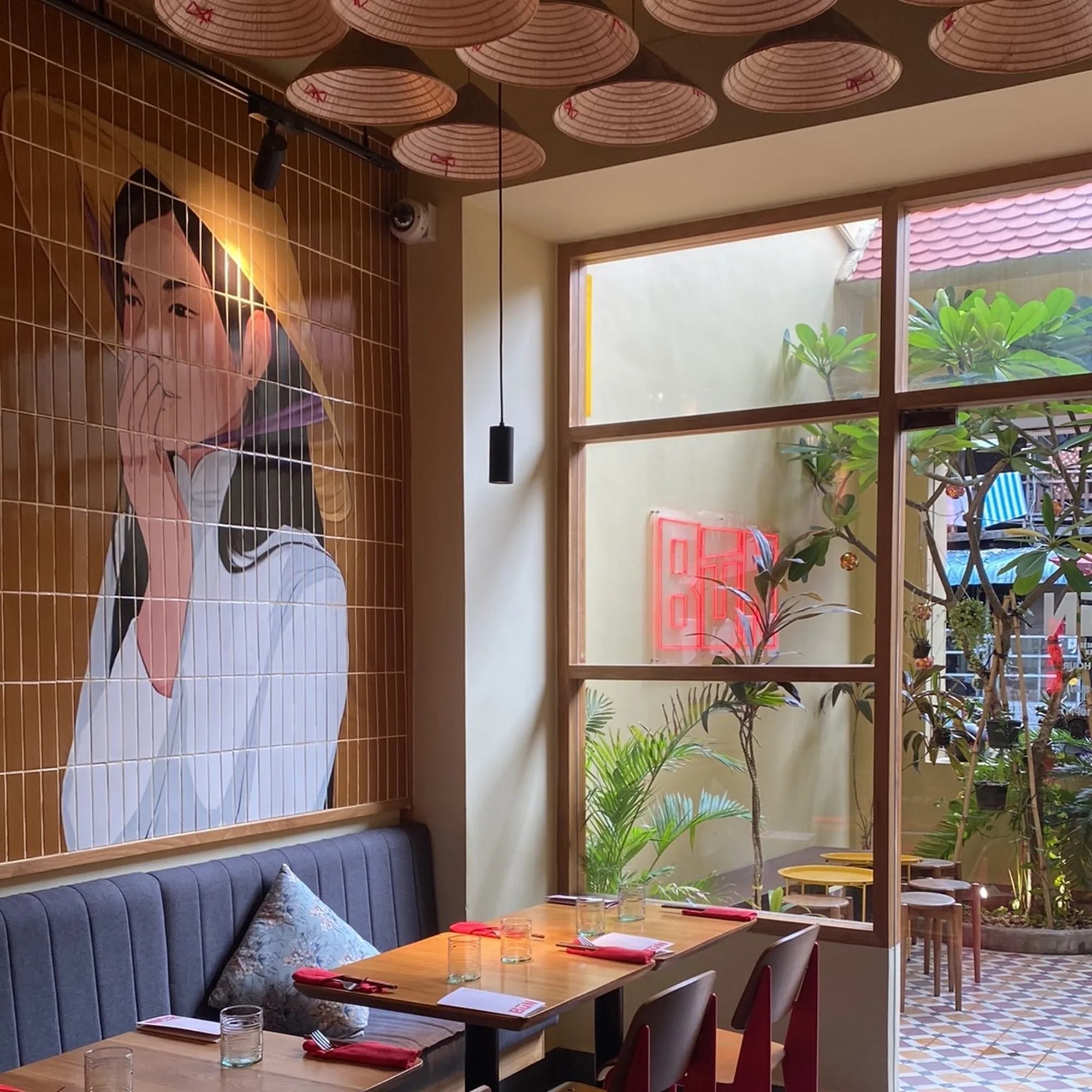 Mural of a woman in an áo dài beside a window